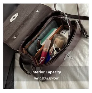 Macro view of internal capacity and brown vintage flap bag compartments showing storage space