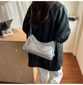 Bolso de hombro en cuero encerado plateado con cadena metálica y textura moderna