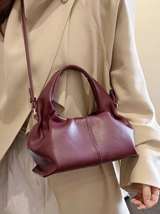 Fashionable burgundy pleated cloud handbag with adjustable shoulder strap and leather texture