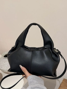 Fashionable black pleated dumpling handbag with rounded handle and slim shoulder strap
