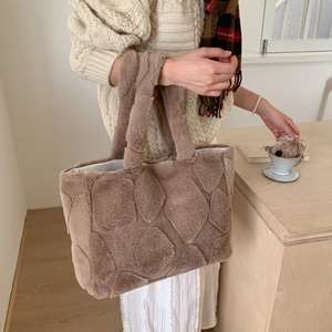 Detail of light brown plush tote bag showing soft quilted faux fur texture and large capacity