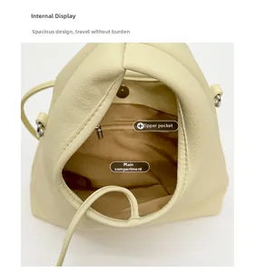Top-down view of cream leather shoulder bag interior with zipper pocket and main compartment