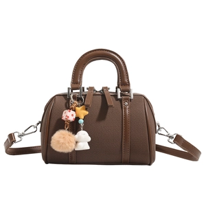 Brown Boston handbag in mini style with plush charms and adjustable shoulder strap