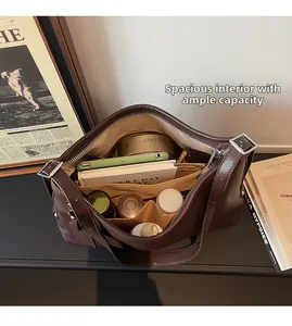 Macro view of a deep brown leather tote bag interior with multiple spacious compartments