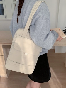 Minimalist beige large capacity crossbody bag with front pocket for daily commute