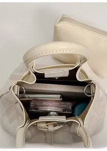 Draufsicht auf cremefarbene Beuteltasche mit Innenraum für Make-up und Handy