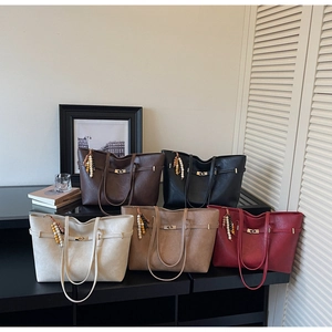 Detail view of five large-capacity tote bags in various colors with decorative beaded charms
