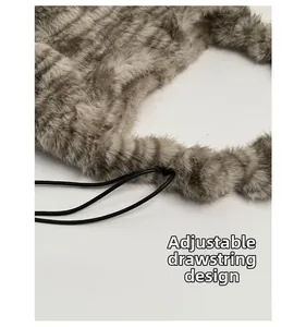 Detail of adjustable drawstring on leopard print plush tote bag for versatile carrying