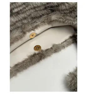 Detail of the magnetic buckle closure on a leopard print plush faux fur tote bag