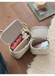 Detail of white quilted crossbody bag set showing interior space for phone and makeup