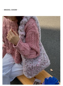 Outdoor lifestyle shot of a model wearing the pink leopard plush shoulder tote bag