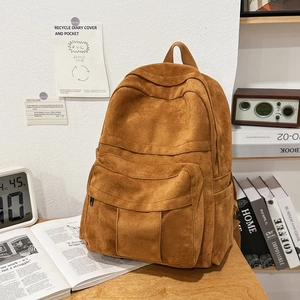 Detail view of the durable corduroy school backpack with multiple storage pockets
