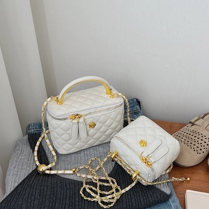 Chic white quilted leather mini crossbody bag set with elegant gold flower hardware and chain