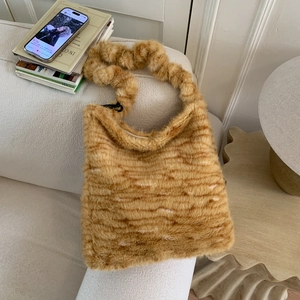 Close-up of fluffy leopard print tote bag on sofa showcasing soft plush texture