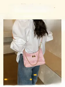 Detail of pink tweed shoulder bag with golden chain and metallic buckle lock