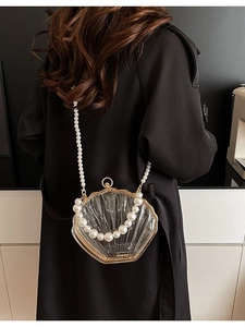 Elegant transparent shell crossbody bag with acrylic finish and long pearl shoulder strap