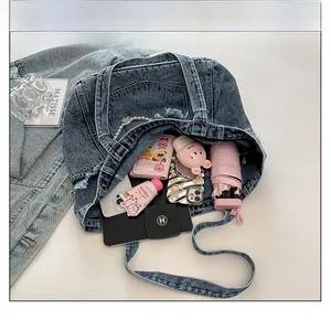 Internal view of blue acid wash denim tote showing high capacity with personal essentials