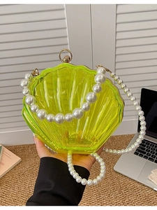 Neon yellow shell shaped acrylic bag with pearl handles and long crossbody pearl strap