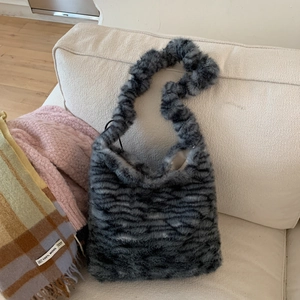 Detail of soft gray faux fur texture and striped pattern on this stylish hobo shoulder bag