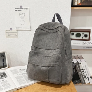 Detail view of dark grey retro canvas backpack with zipper pocket for school