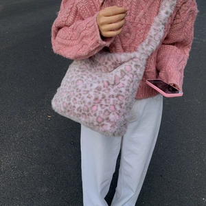 Close-up of pink leopard print plush shoulder bag featuring soft faux fur texture