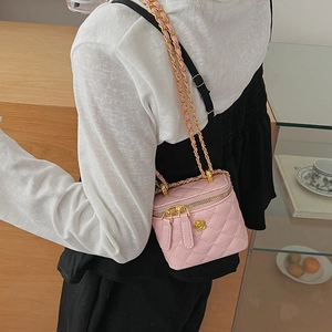 Pink quilted leather mini crossbody bag with chain strap shown for styling and size