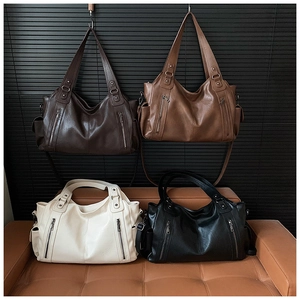 Multiple views of large capacity tote bags in four colors with functional outer pockets