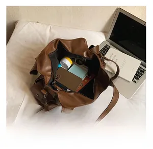 Top view of large brown faux leather tote bag showing spacious interior and zip closure