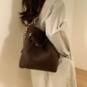 Detail of dark brown faux suede tote bag with leopard print scarf and gold buckle hardware