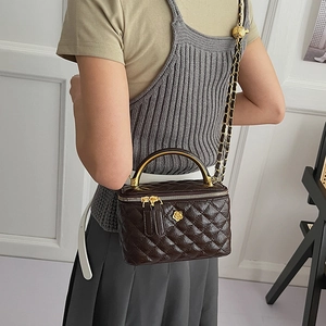 Deep brown quilted leather crossbody bag featuring a golden camellia flower clasp and chain