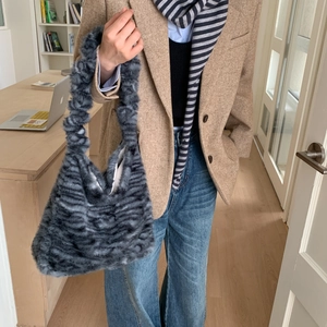 Detail showing the zebra pattern plush texture of this soft faux fur tote shoulder bag