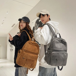Detailed view of high-capacity canvas backpacks with multiple zippers and side pockets