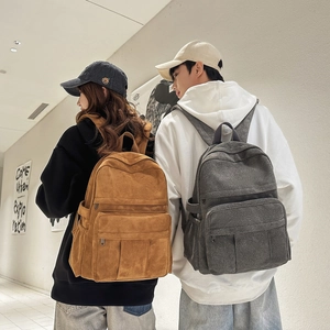 Close-up of corduroy backpack texture and side pockets for water bottles