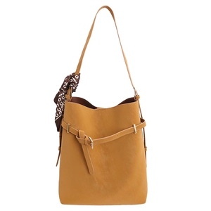 Vintage ginger yellow tote bag with decorative silk scarf and adjustable strap on white background