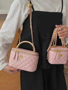 Pink quilted leather chain bag with camellia detail and gold hardware in two sizes