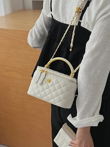 Quilted white crossbody box bag with gold floral clasp and adjustable gold ball chain