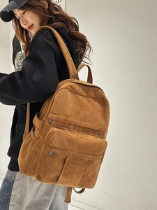 Vintage brown canvas backpack with large capacity and multi-pocket design for students