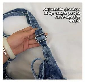 Detail of adjustable denim shoulder strap with silver buckle for customized length