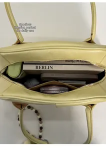 Top view of yellow leather tote bag with high capacity for daily commute essentials