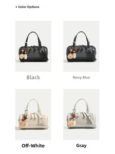 Detail view of stylish Boston bags in black, navy, beige and grey with cute pendants