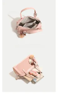 Macro view of pink Boston bag interior featuring multiple compartments for daily items