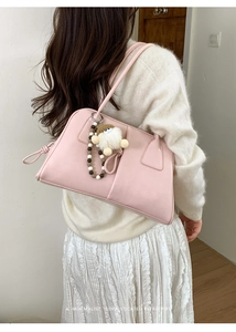 Pink faux leather shoulder bag featuring plush charm and beaded strap decorations