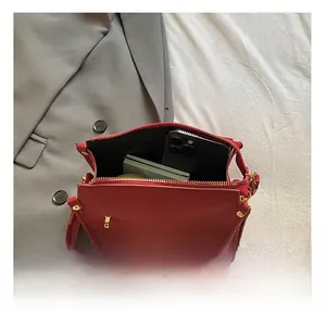 Top view of red matte leather handbag interior showing storage capacity for daily items