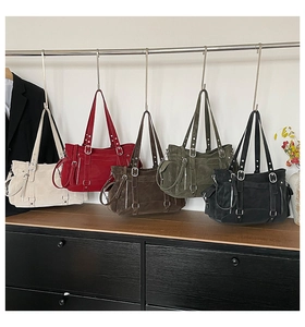 Detailed row of large capacity tote bags in five colors with metal buckle accents