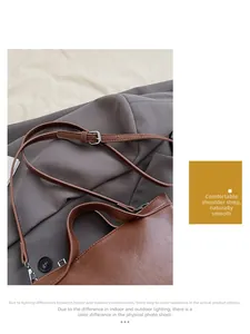 Detail of dark brown leather handbag with adjustable strap and silver metal hardware