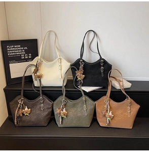 Row of minimalist tote bags in five earthy tones with bear charms and adjustable straps