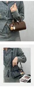 Detail of Boston style handbags with bear charms and adjustable shoulder straps