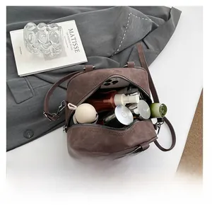 Interior view showing large capacity of the vintage brown shoulder bag for daily essentials