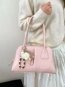 Pink faux leather underarm bag with geometric stitching and plush charm for women
