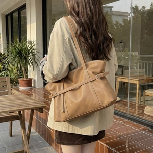 Large vintage brown tote bag in soft faux leather with decorative buckle strap details